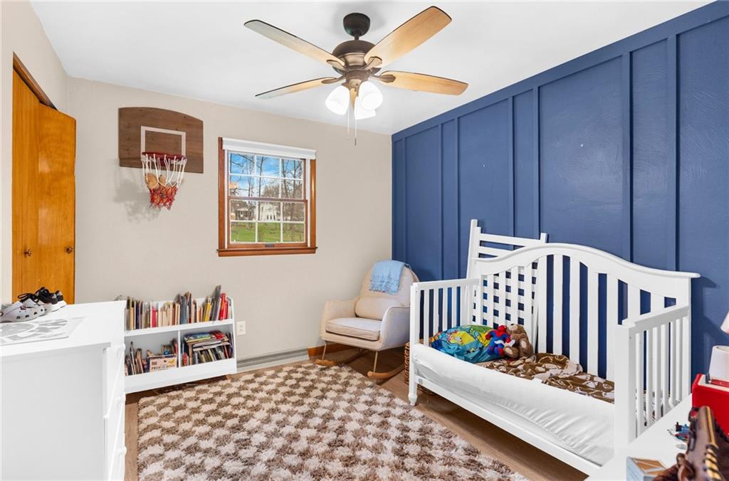 115 Milton Street Clark, PA 16113 - Photo 11 of 24 a living room with furniture and a baby crib