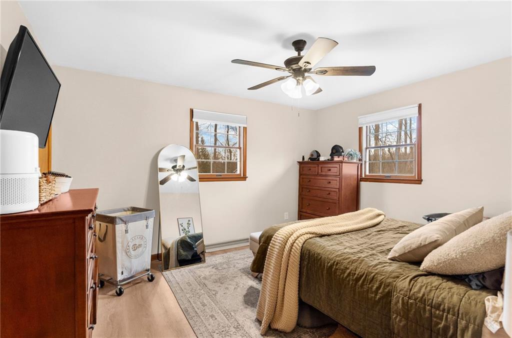 115 Milton Street Clark, PA 16113 - Photo 9 of 24 a bedroom with a bed and wooden floor