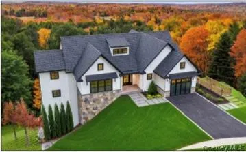 a aerial view of a house with table and chairs under an umbrella
