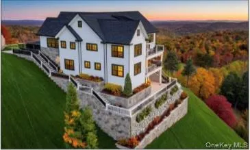 a view of a big house with a big yard and large trees