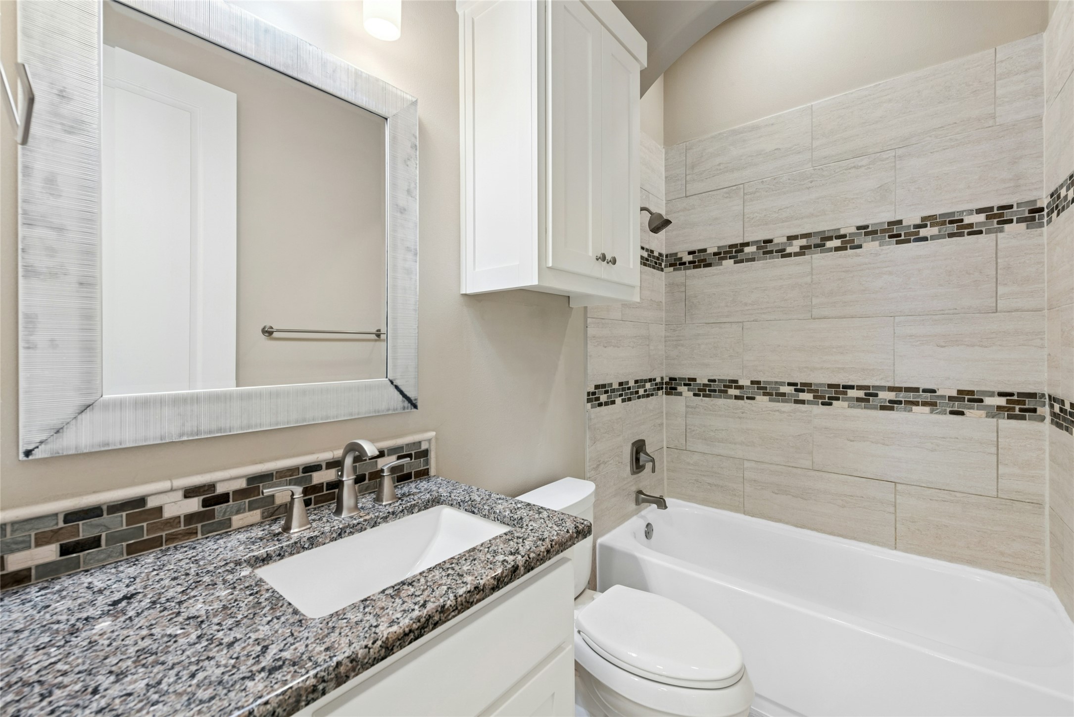 4301 Mansfield Dam Road, Unit 2101 Austin, TX 78734 - Photo 14 of 17 Full bath featuring tub / shower combination, vanity, and decorative backsplash