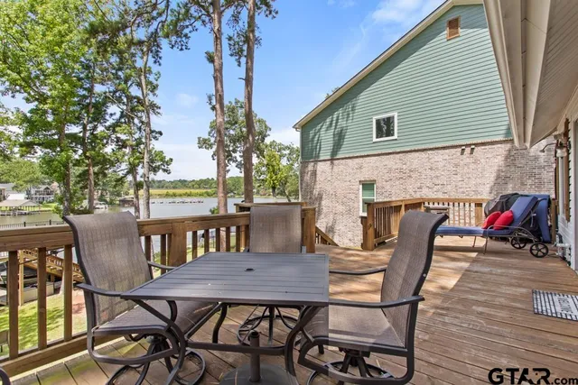 a view of a patio with table and chairs and potted plants