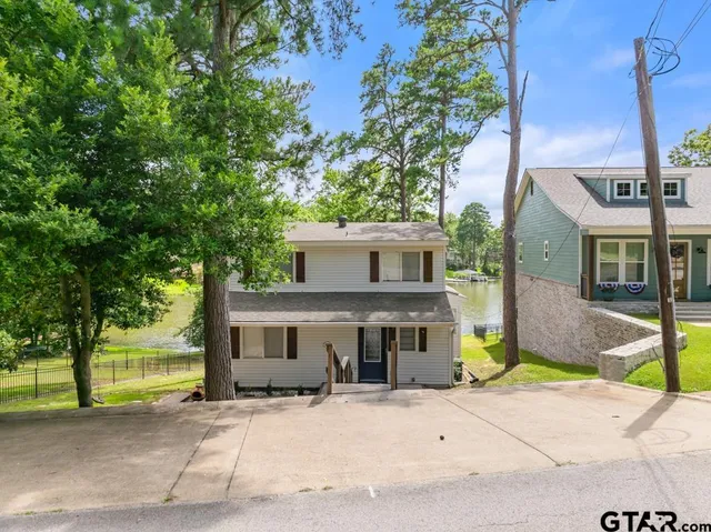 a front view of a house with a yard and a garage