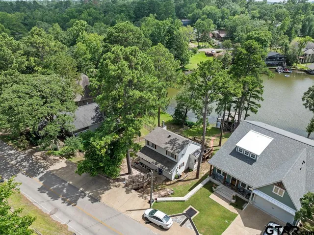an aerial view of a house with garden space and street view