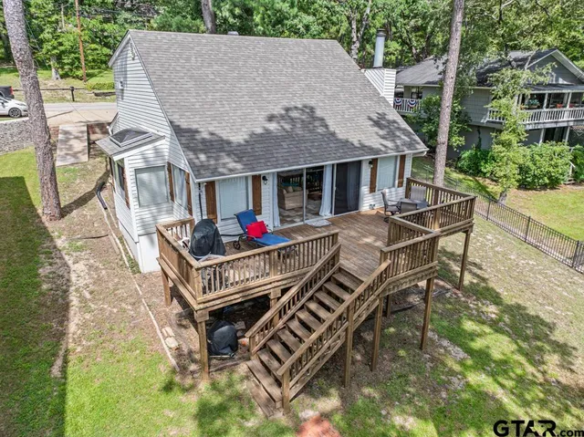 a swimming pool with outdoor seating and yard