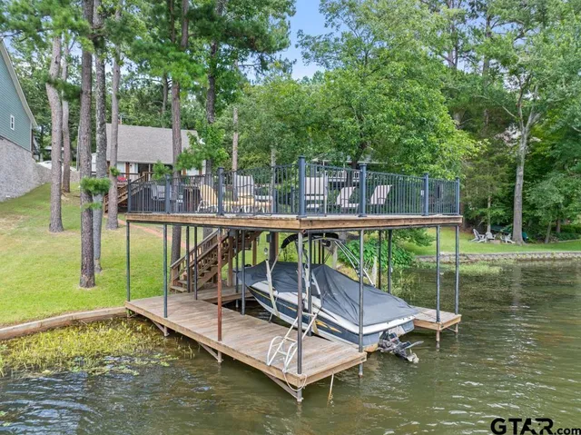 a swimming pool with outdoor seating and yard