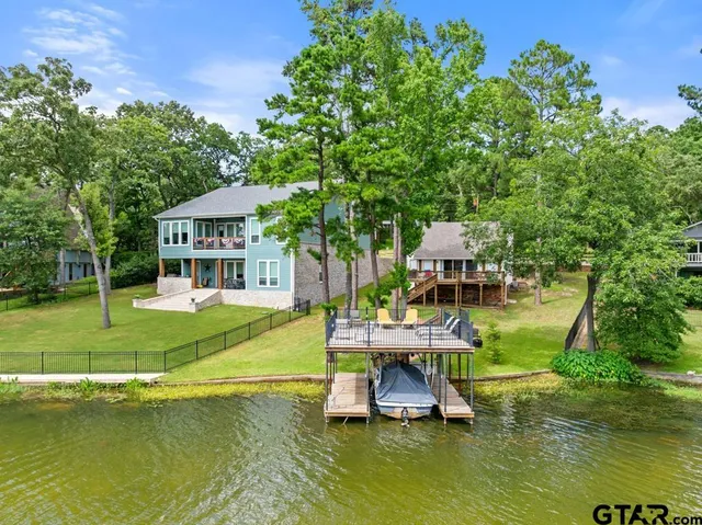 an aerial view of a house with a yard