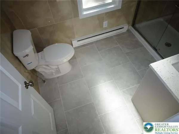 a bathroom with a toilet and a shower