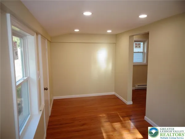 a view of hallway with wooden floor