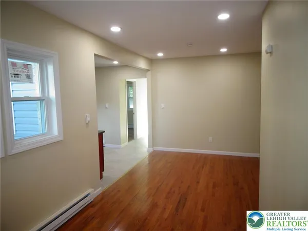 a view of hallway with wooden floor