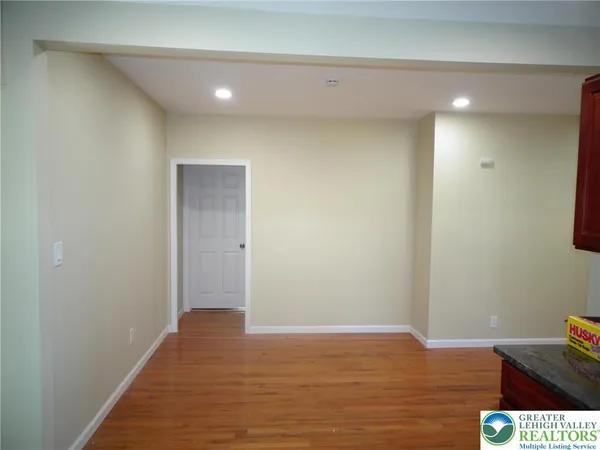 a view of hallway with wooden floor