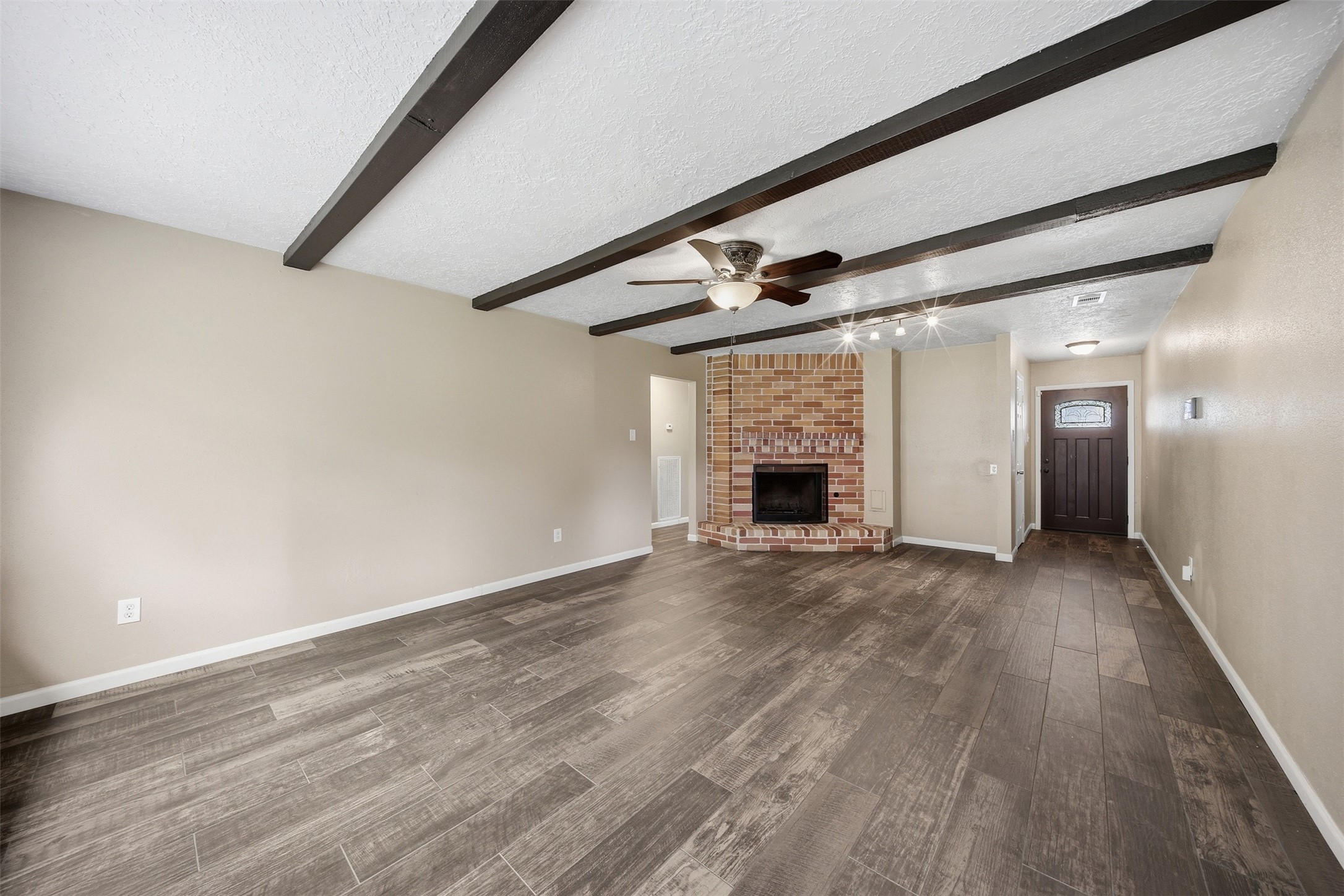 9418 Kilrenny Drive Spring, TX 77379 - Photo 17 of 47 an empty room with wooden floor and fireplace