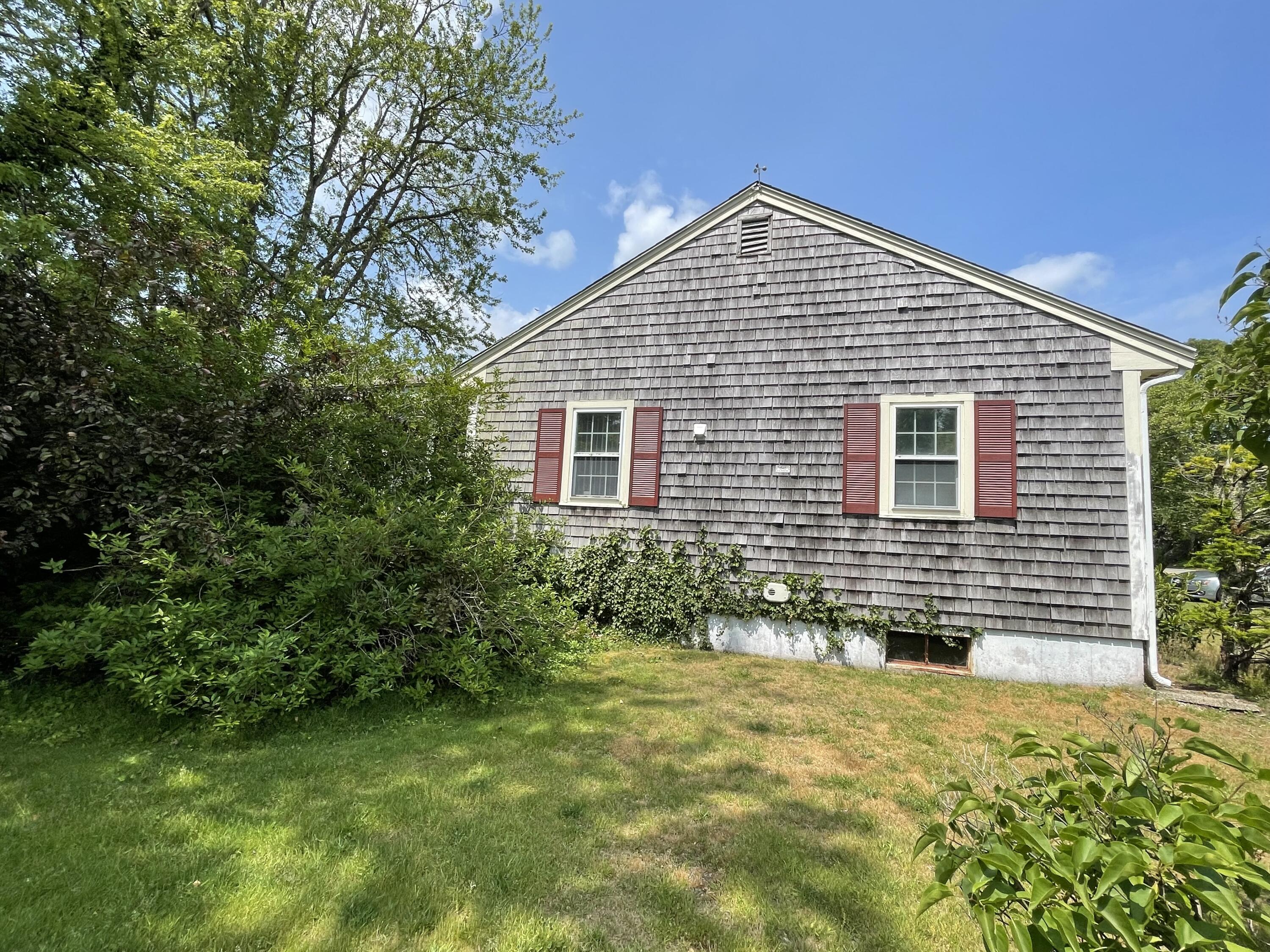 21 Long Road Harwich, MA 02645 - Photo 7 of 18 a front view of a house with a yard