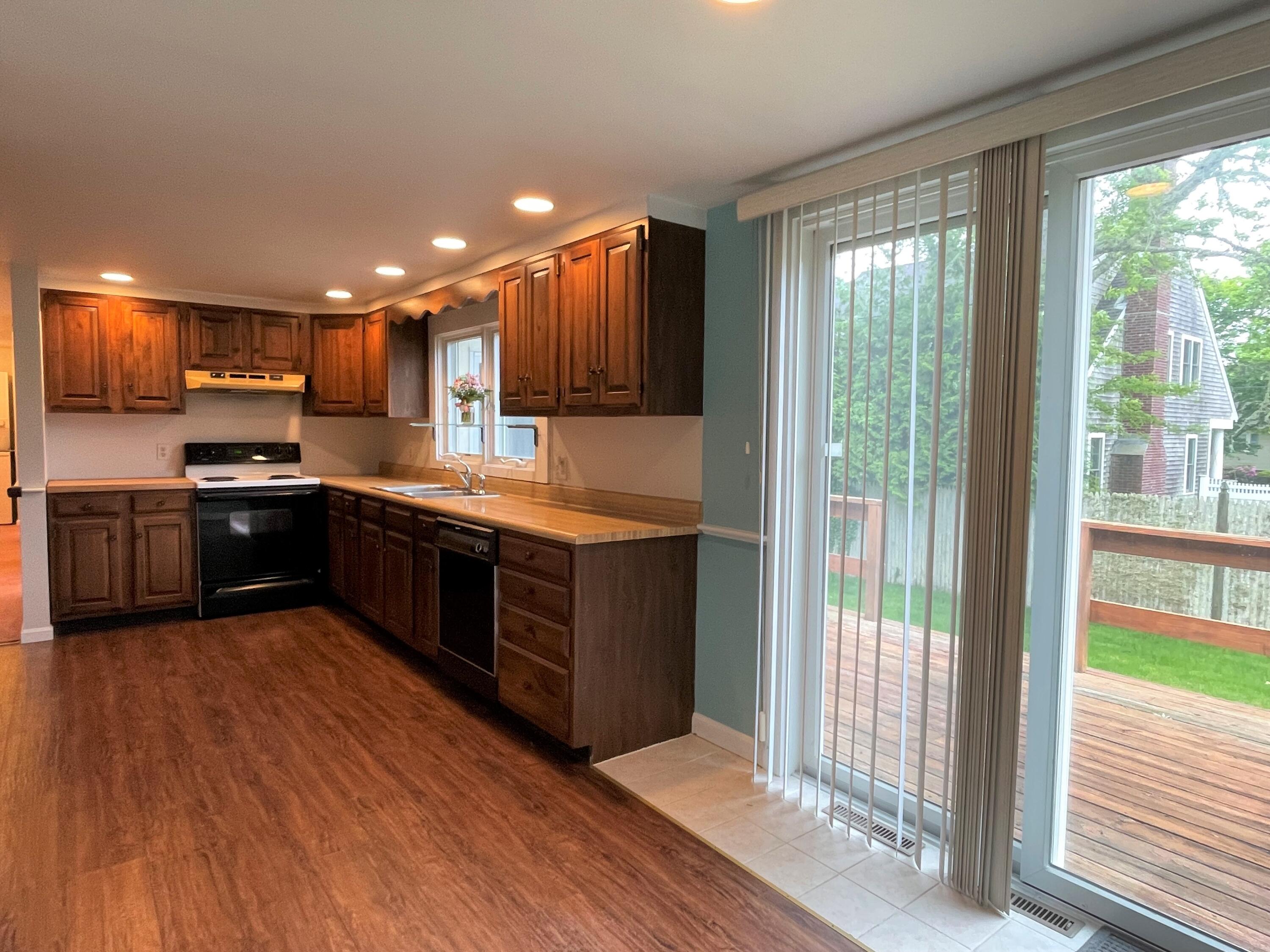 21 Long Road Harwich, MA 02645 - Photo 10 of 18 a large kitchen with a large counter top a sink stainless steel appliances and cabinets