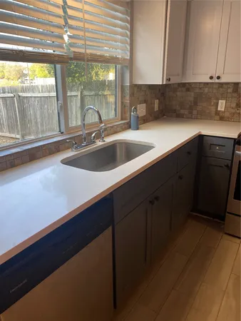 a kitchen with a sink and large window