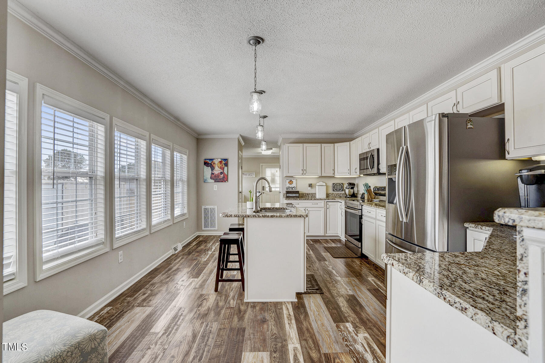 1645 Denning Road Benson, NC 27504 - Photo 14 of 17 a kitchen with kitchen island a counter top space a sink appliances and cabinets
