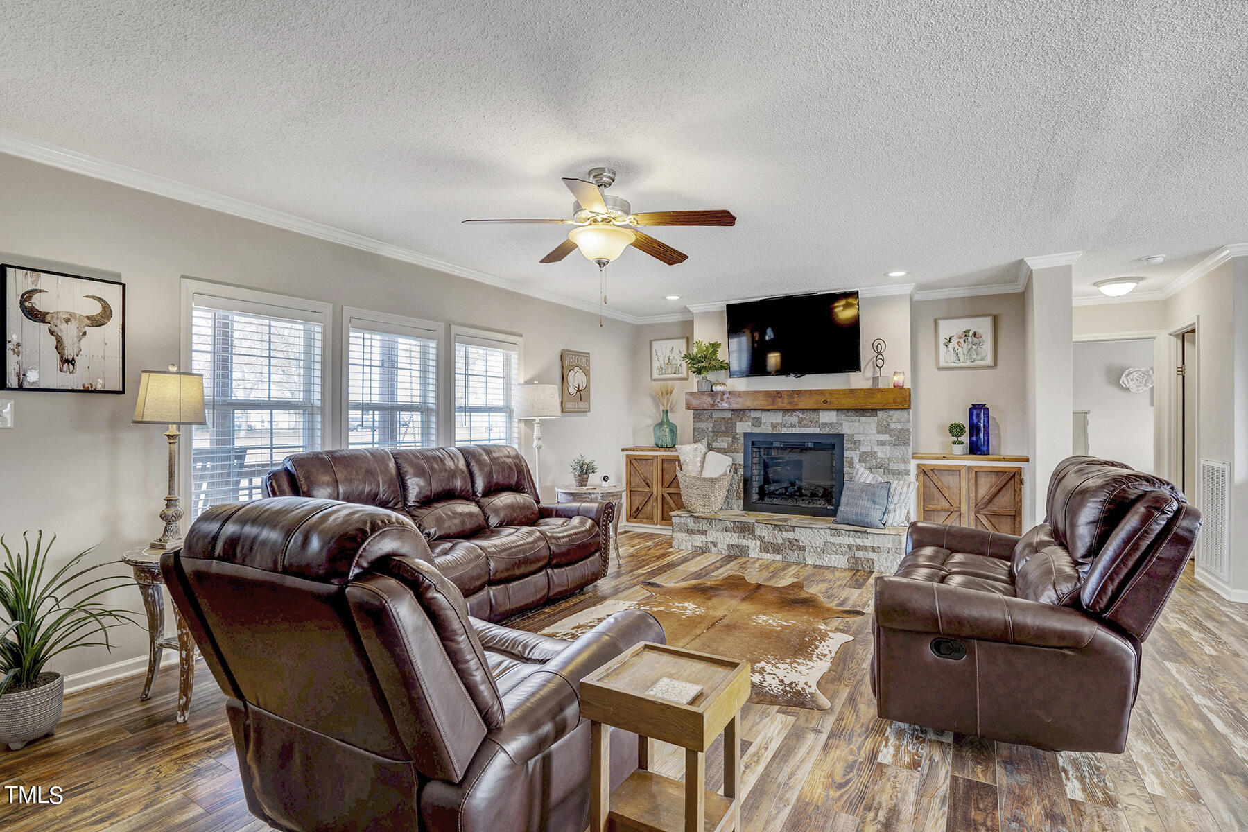 1645 Denning Road Benson, NC 27504 - Photo 15 of 17 a living room with furniture a flat screen tv and a fireplace