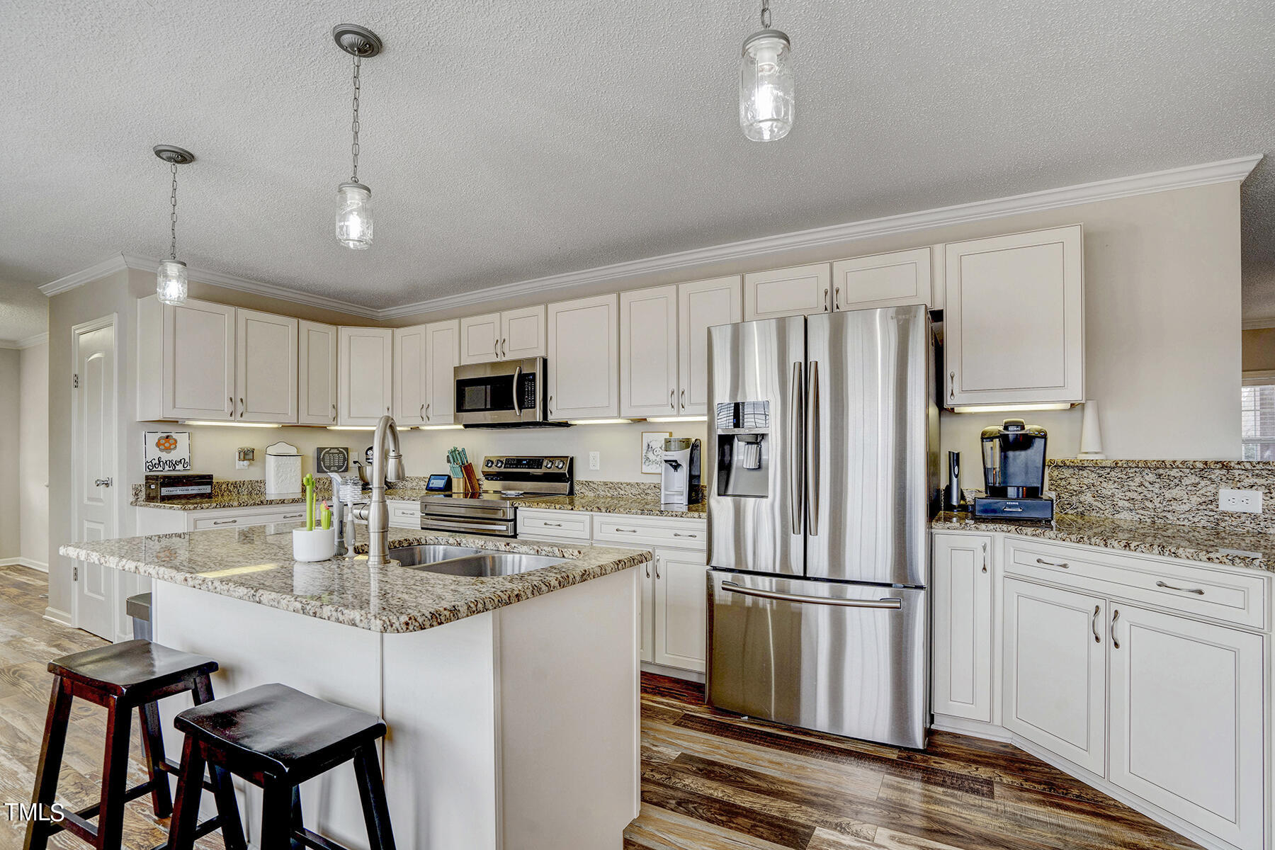 1645 Denning Road Benson, NC 27504 - Photo 3 of 17 a kitchen with refrigerator a stove a sink and chairs