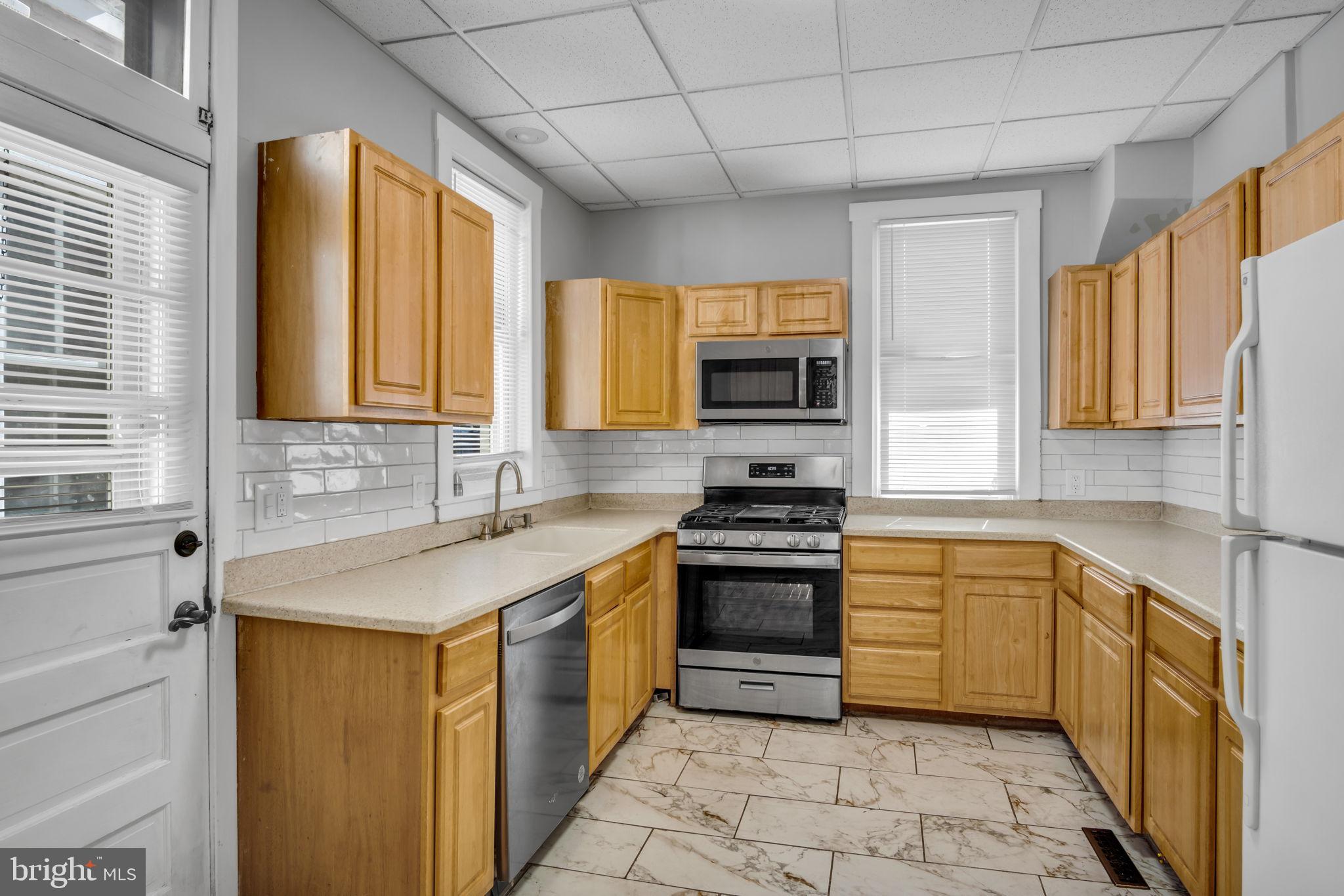 211 Cumberland Street Harrisburg, PA 17102 - Photo 15 of 26 a kitchen with stainless steel appliances a stove sink and microwave