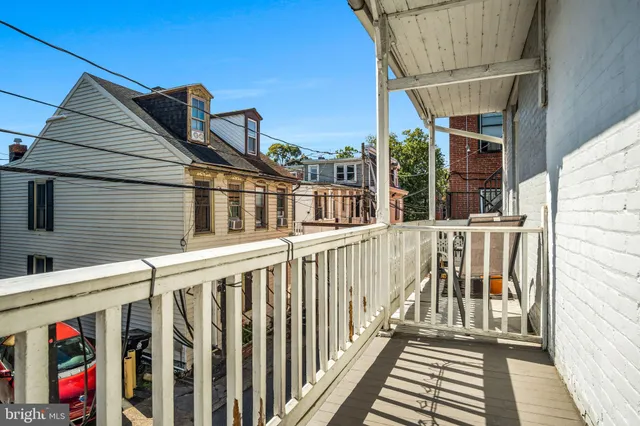 a view of small house with wooden floor and fence