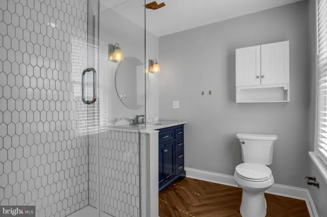 a bathroom with a toilet sink and mirror
