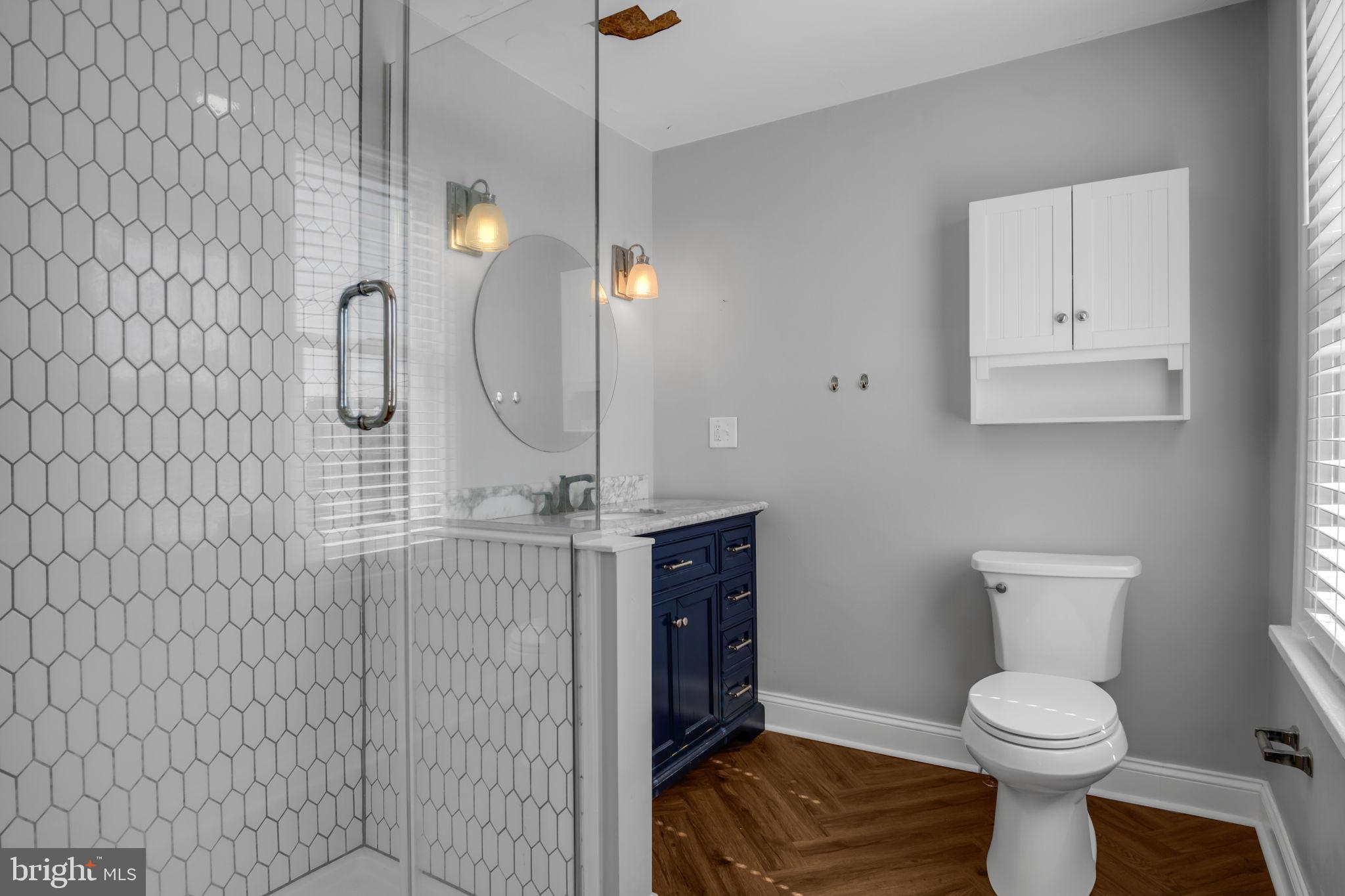 211 Cumberland Street Harrisburg, PA 17102 - Photo 25 of 26 a bathroom with a toilet sink and mirror