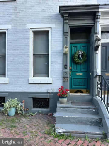 a front view of a house with outdoor seating