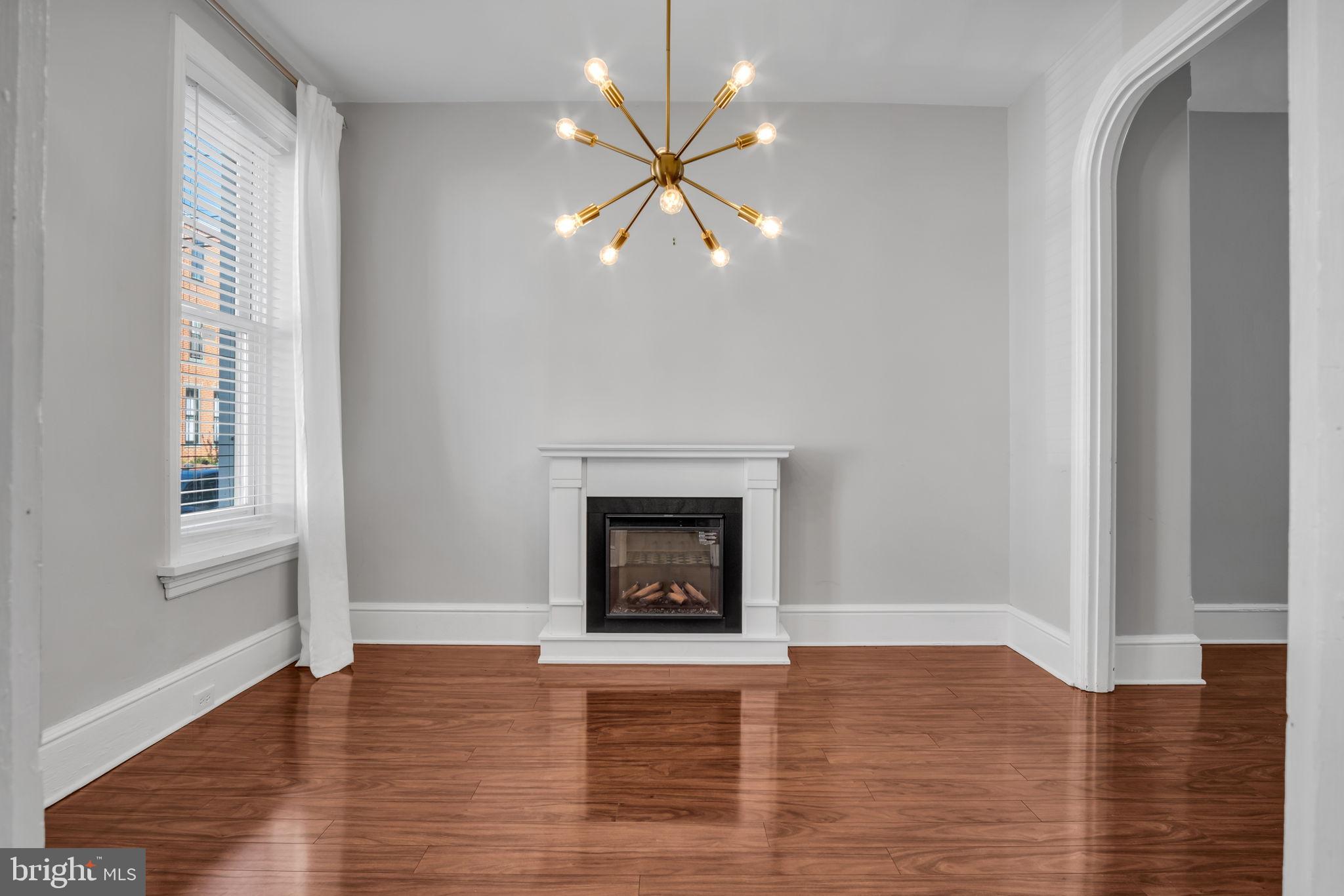 211 Cumberland Street Harrisburg, PA 17102 - Photo 10 of 26 wooden floor fireplace and windows in an empty room