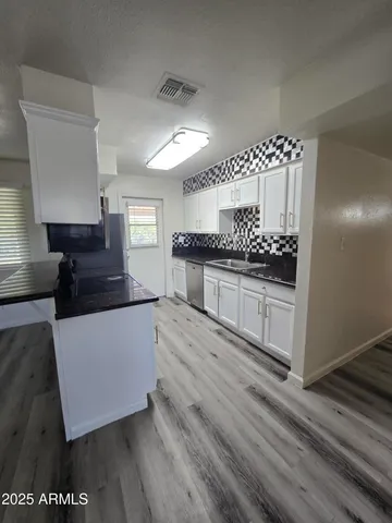 a kitchen with stainless steel appliances granite countertop a stove and a refrigerator