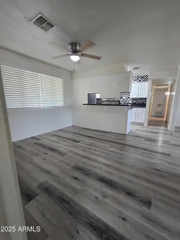 a view of kitchen and empty room