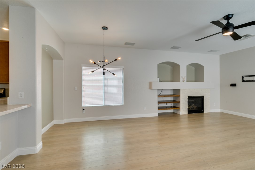 8909 Houston Ridge Avenue Las Vegas, NV 89178 - Photo 10 of 45 A generous living area showcases a sleek fireplace and ample room for relaxation.