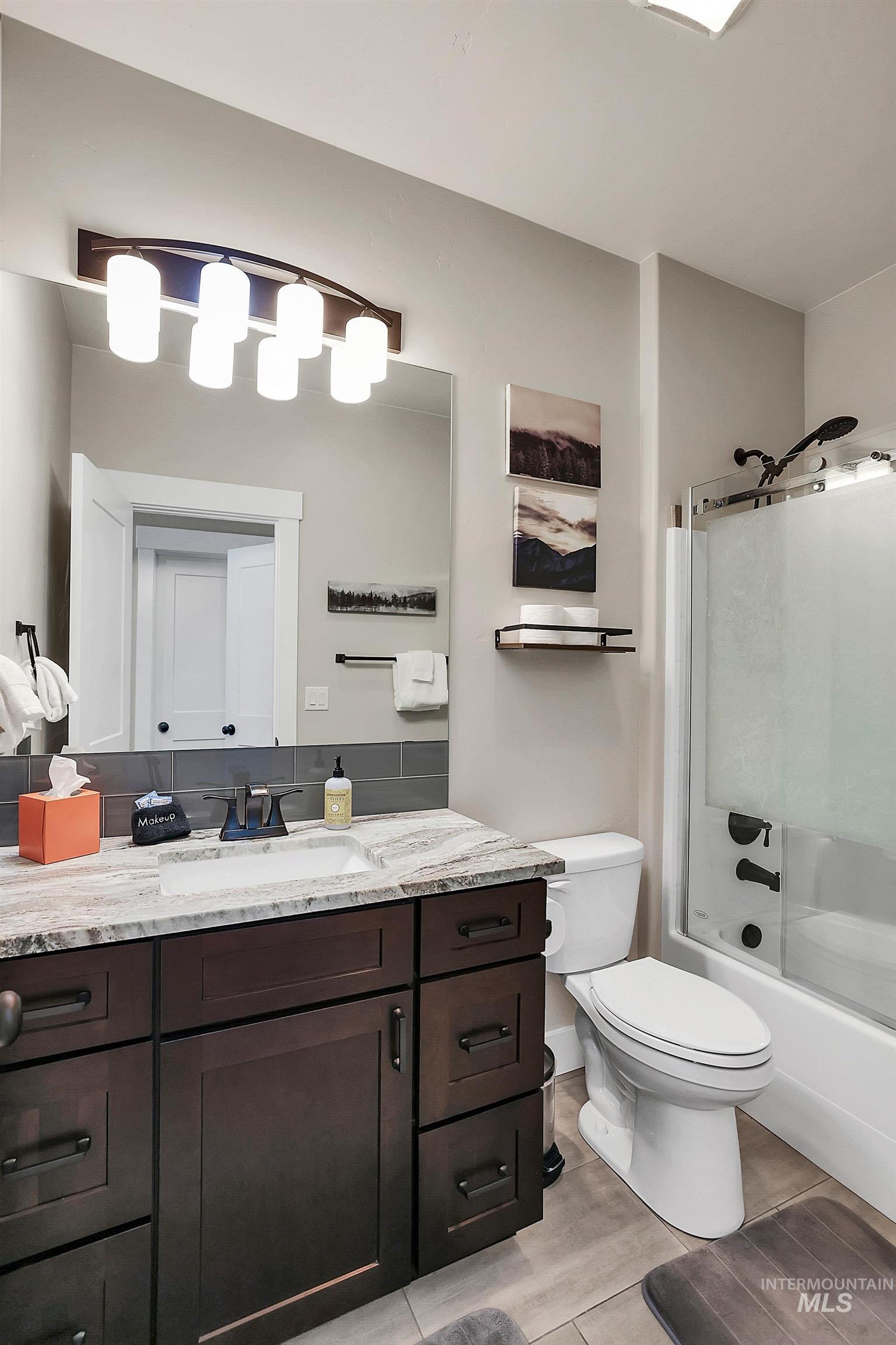 609 Blue Water Circle McCall, ID 83638 - Photo 21 of 45 Full bath featuring vanity, shower / bath combination with glass door, and wood tiled floors