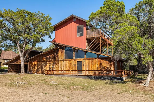 a front view of a house with swimming pool and sitting area