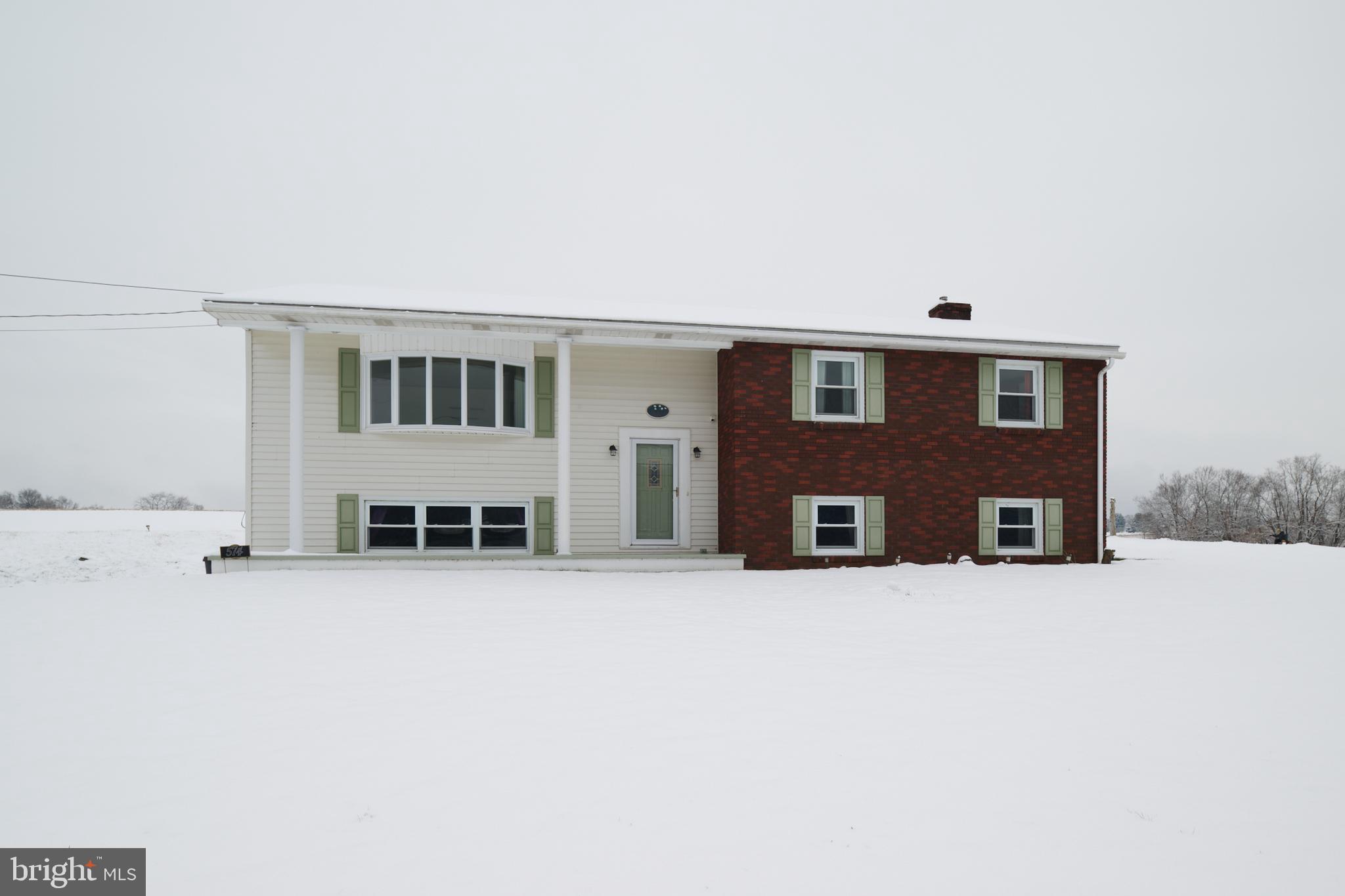 a view of a house with large windows and yard