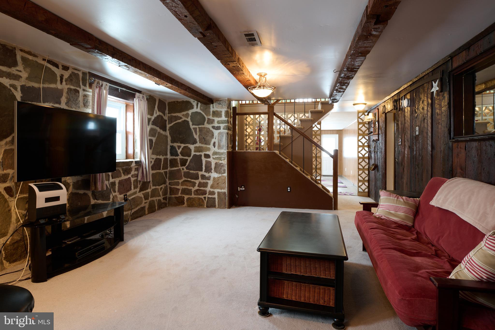574 Buffalo Run Road Bellefonte, PA 16823 - Photo 22 of 54 a living room with furniture and a flat screen tv
