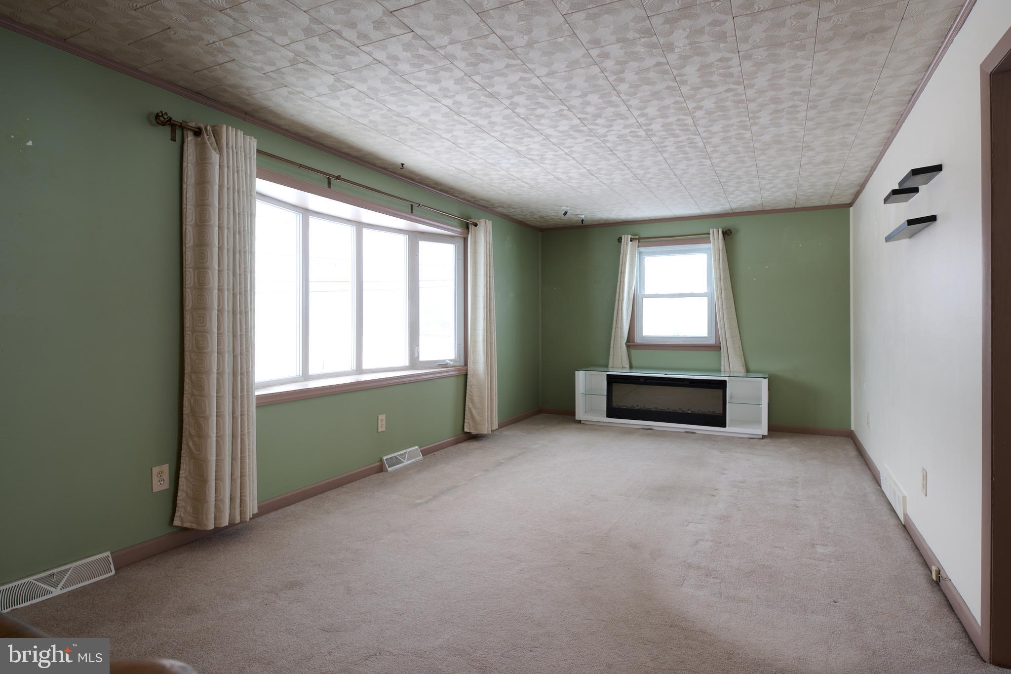 574 Buffalo Run Road Bellefonte, PA 16823 - Photo 28 of 54 an empty room with a window and a kitchen
