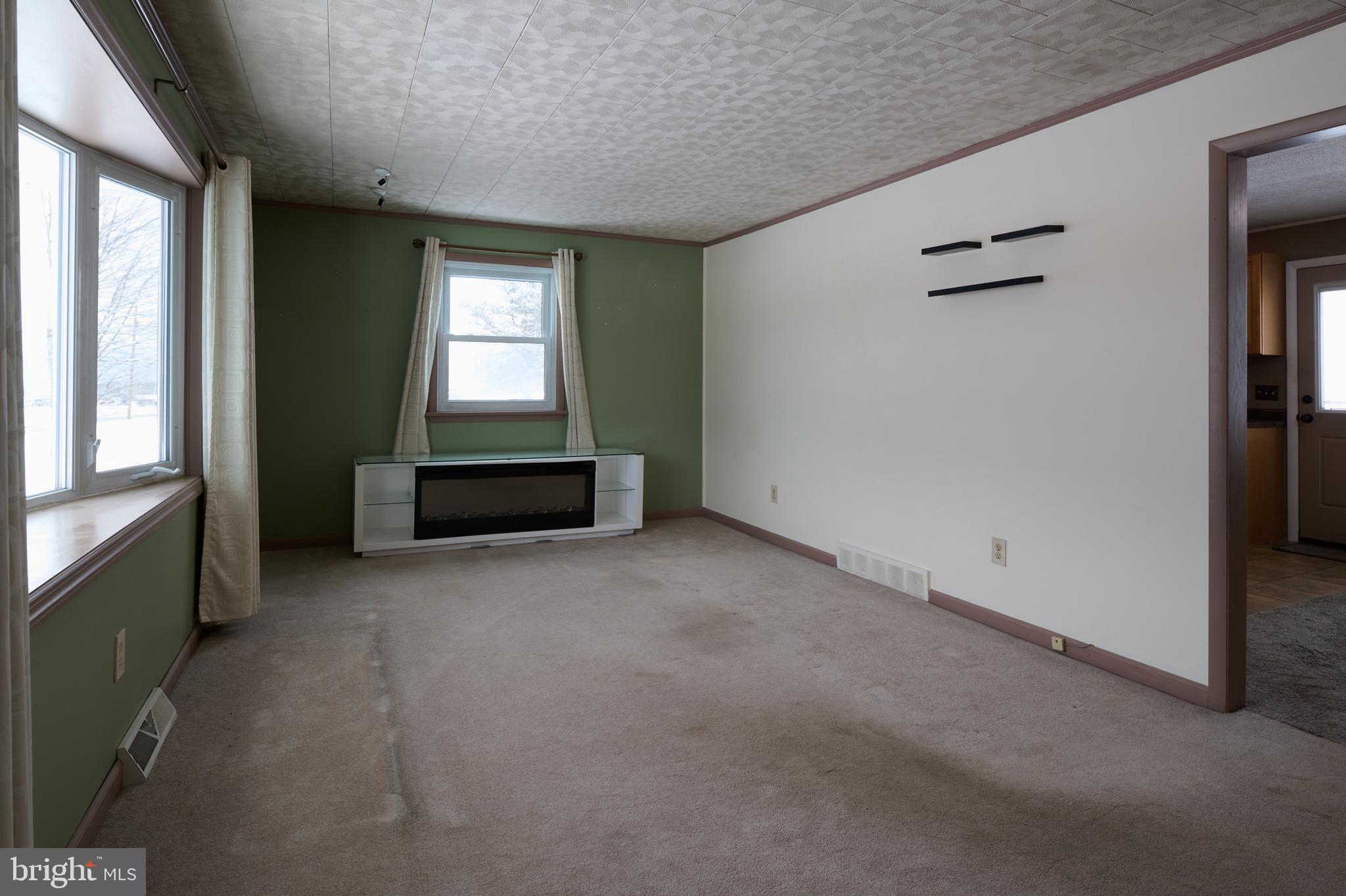 574 Buffalo Run Road Bellefonte, PA 16823 - Photo 29 of 54 an empty room with a window and chandelier