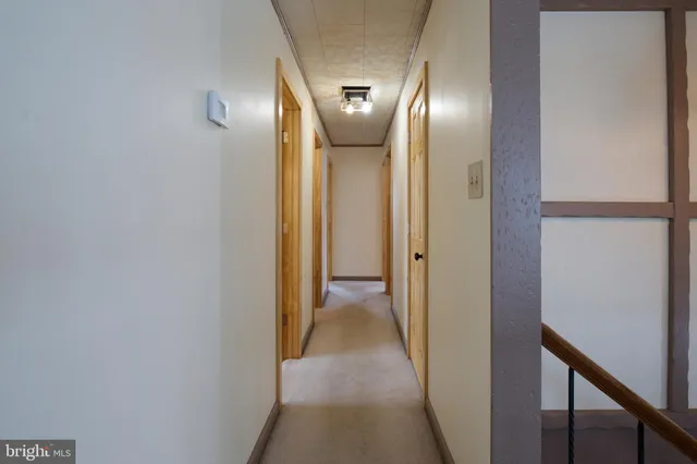 an empty room with wooden floor and closet area