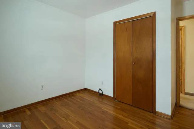 a view of a room with wooden floor and fan