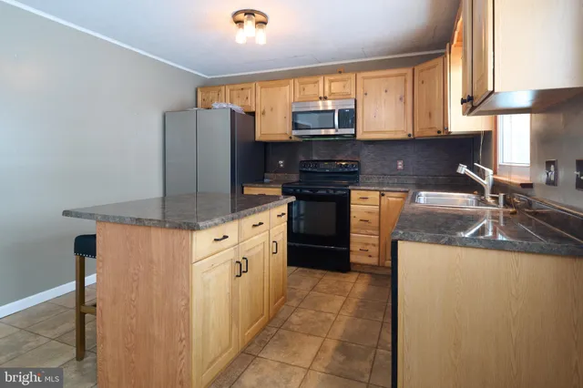 a kitchen with granite countertop a sink and a window