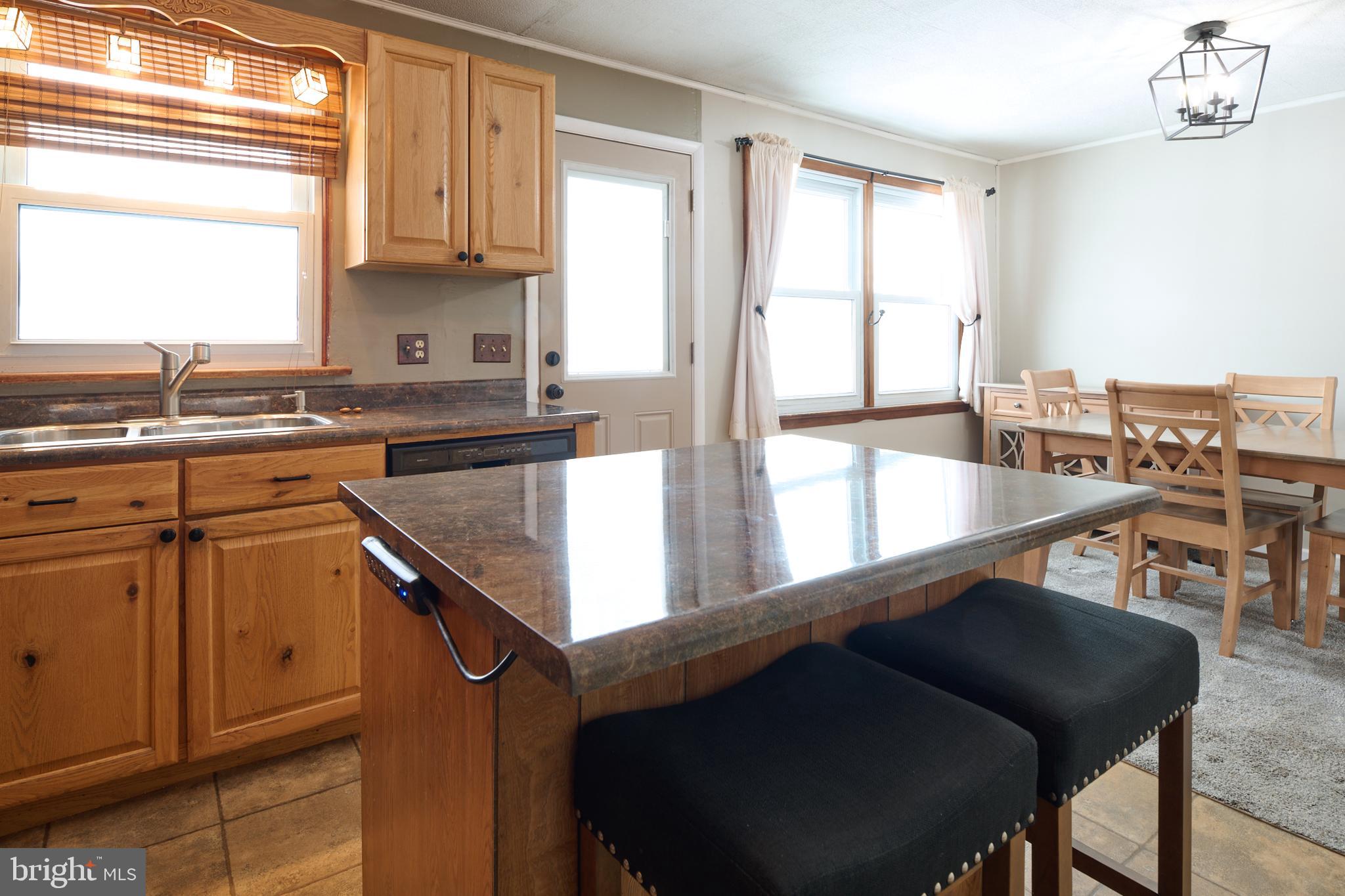 574 Buffalo Run Road Bellefonte, PA 16823 - Photo 10 of 54 a kitchen with a table chairs sink and cabinets