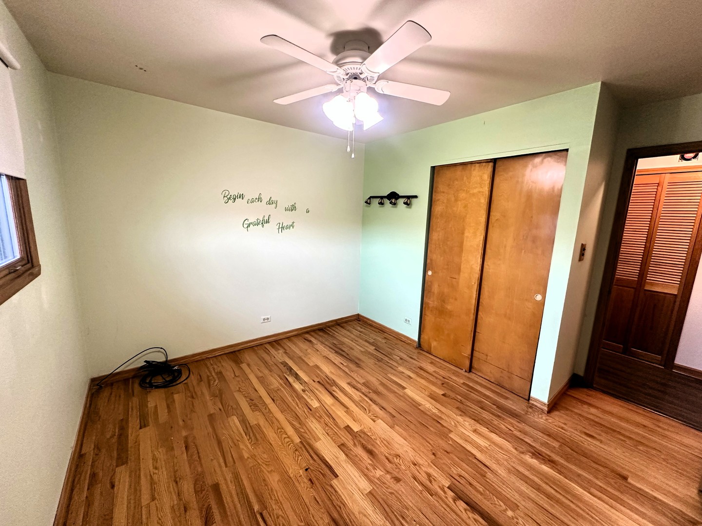 9112 Homestead Lane Bridgeview, IL 60455 - Photo 16 of 29 wooden floor in an empty room with a window