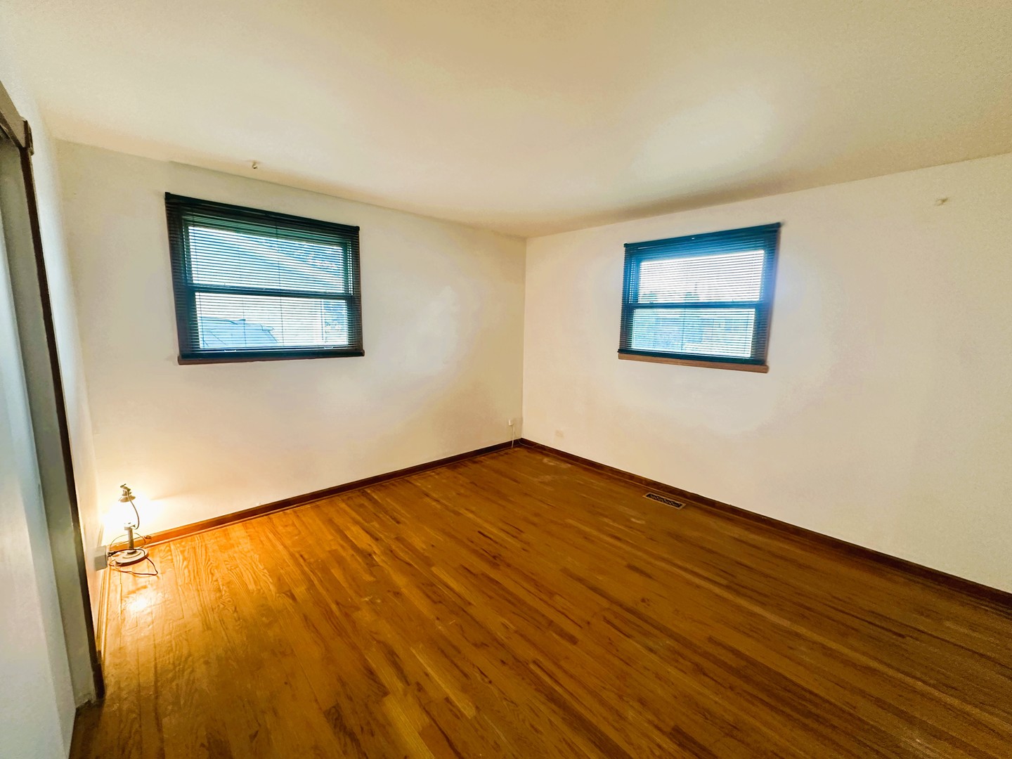 9112 Homestead Lane Bridgeview, IL 60455 - Photo 17 of 29 a view of an empty room with wooden floor and a window