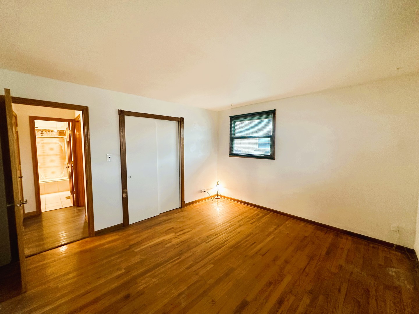 9112 Homestead Lane Bridgeview, IL 60455 - Photo 18 of 29 a view of an empty room with wooden floor and a window