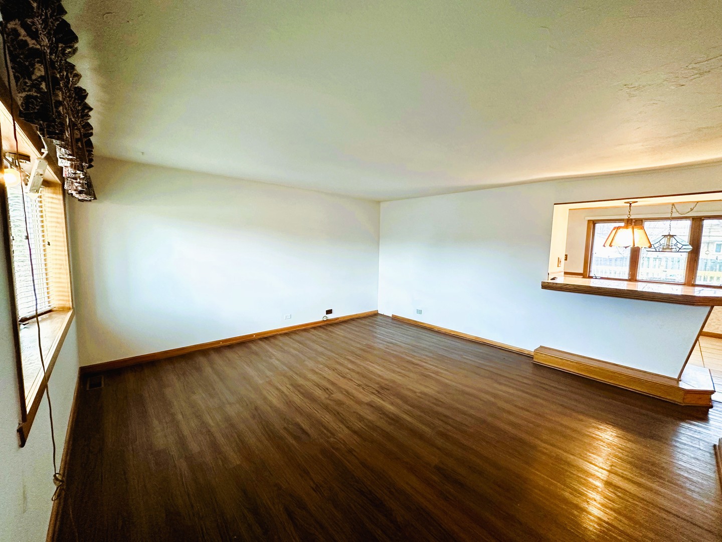 9112 Homestead Lane Bridgeview, IL 60455 - Photo 4 of 29 an empty room with wooden floor and windows