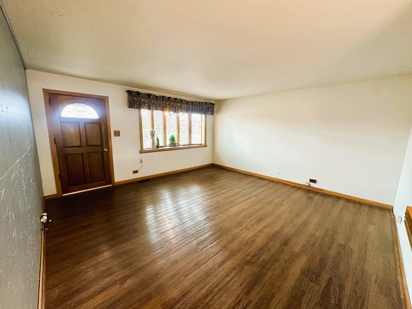 9112 Homestead Lane Bridgeview, IL 60455 - Photo 7 of 29 an empty room with wooden floor and windows
