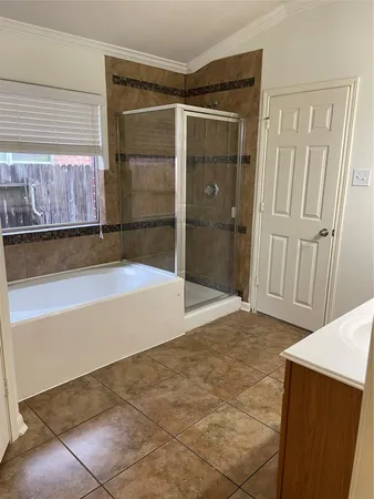 a bathroom with a tub and shower