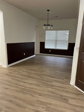 a view of a room with wooden floor