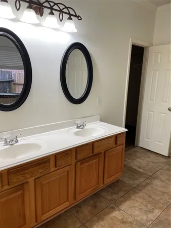 a bathroom with a double vanity sink and a mirror