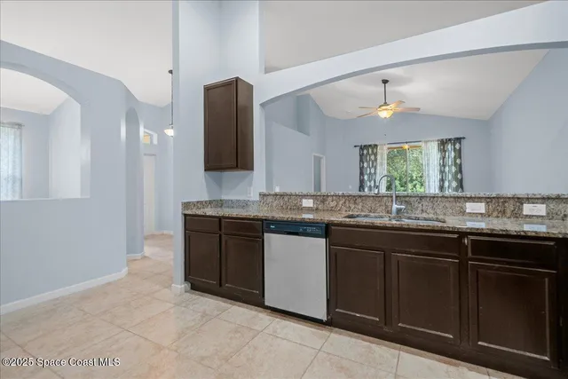 a bathroom with a granite countertop sink and a large mirror
